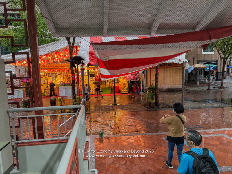 a group of people walking on a sidewalk