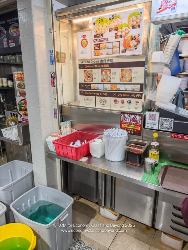a kitchen with a counter and buckets of food