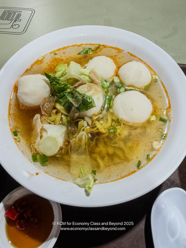 a bowl of soup with meatballs and vegetables