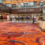 an airport with people walking around