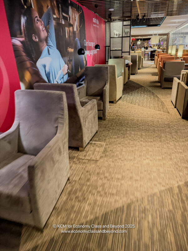 a room with chairs and a poster