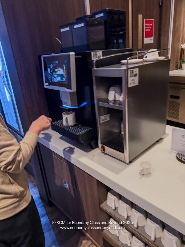 a person standing at a counter with a machine