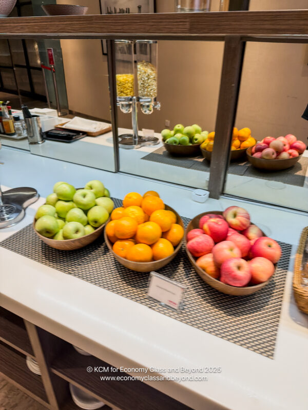 a group of bowls of fruit on a counter