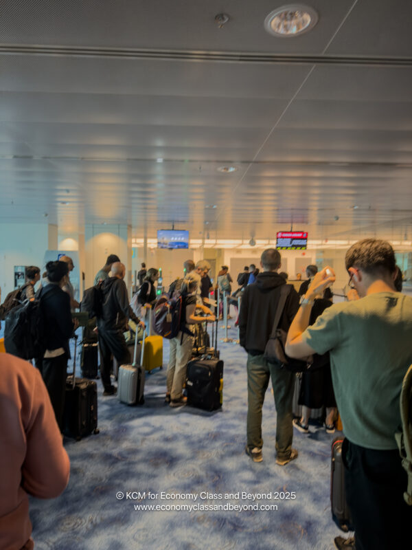 a group of people with luggage in an airport