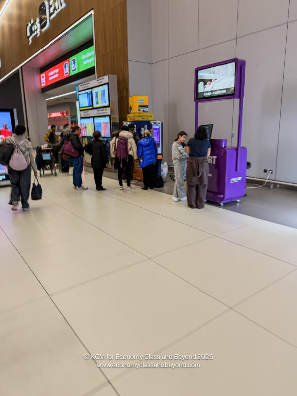 people standing in a line at an airport
