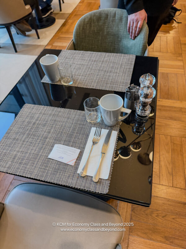 a table with a glass and silverware