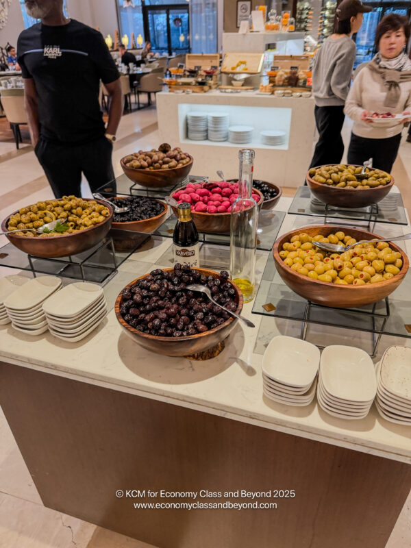 a group of bowls of olives and other food on a table