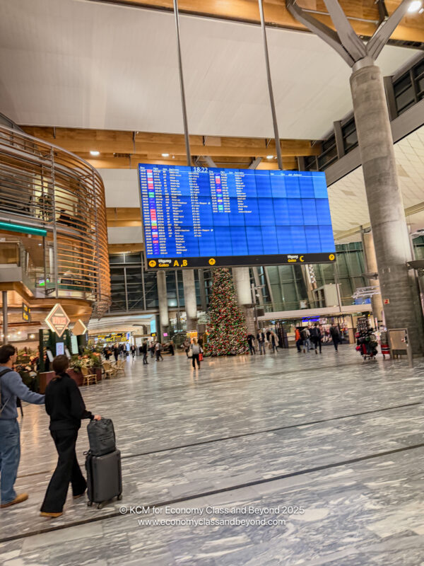 a group of people walking in a large airport terminal