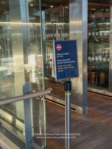 a sign in front of a glass door