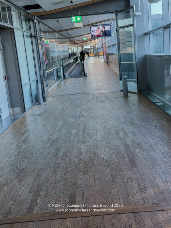 a wooden floor with glass walls and a walkway
