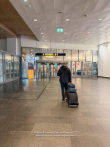 a man pulling luggage in a building