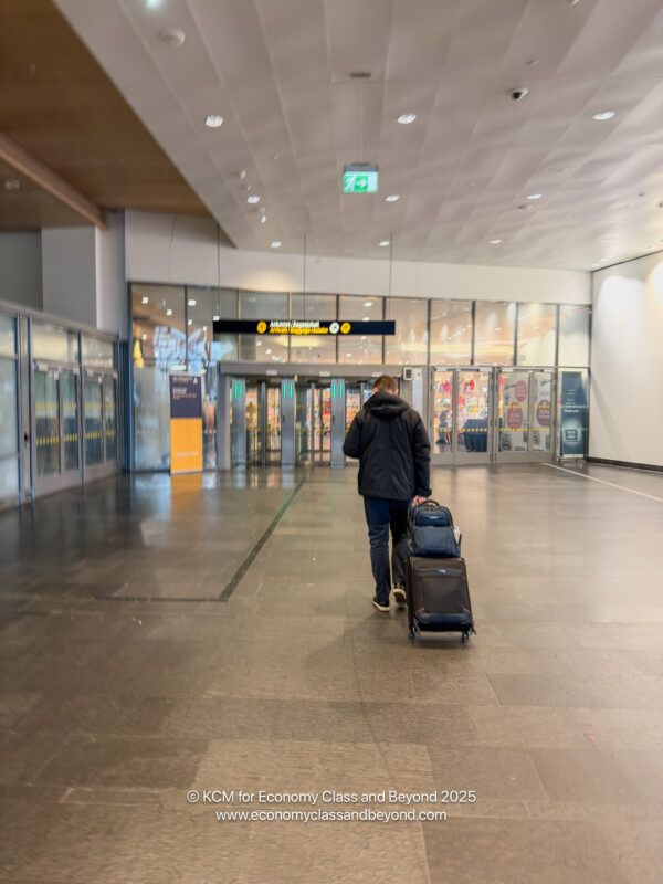 a man pulling luggage in a building