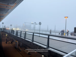 a group of people walking on a sidewalk