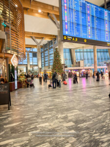 a large airport terminal with a large screen