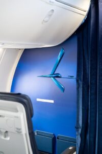 a blue clock on a blue wall