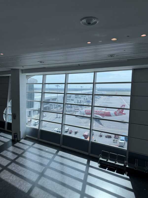 a large window with a plane in the background