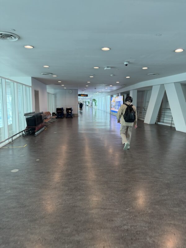 a man walking in a large white building