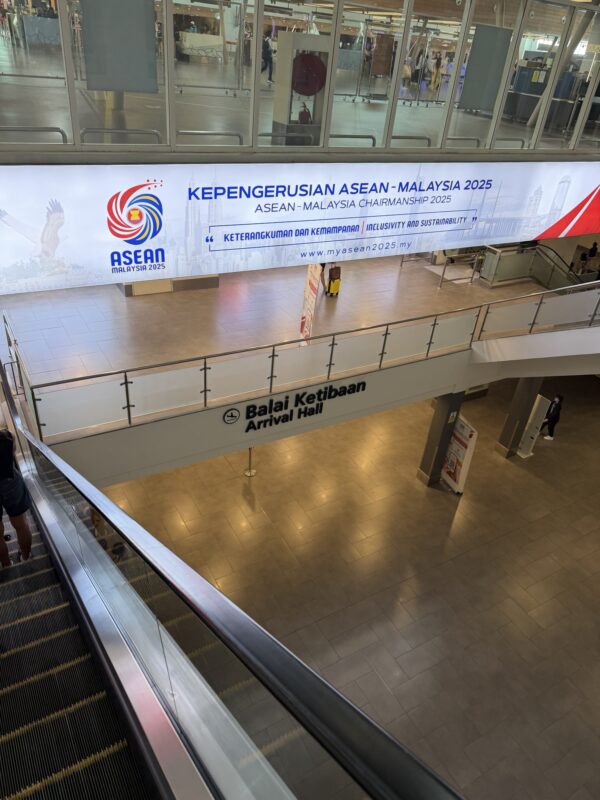 an escalator and a sign in a building