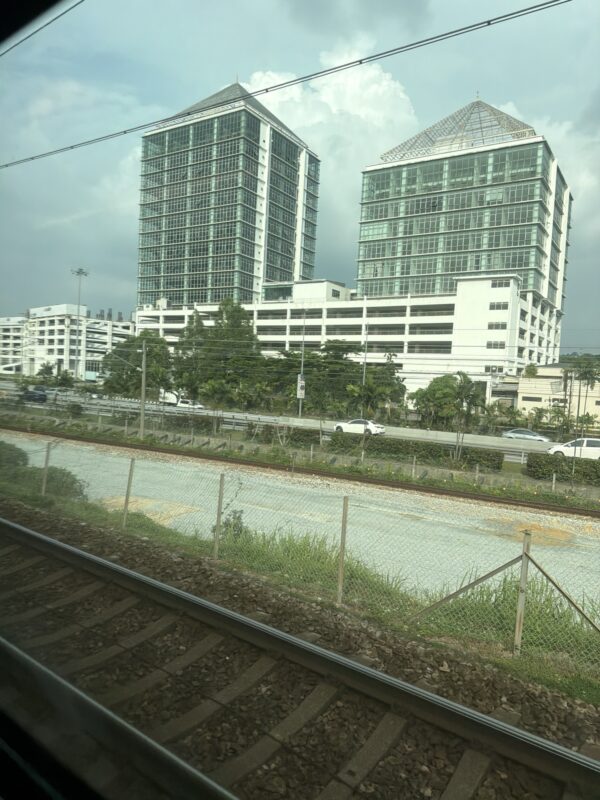 a train tracks next to a city