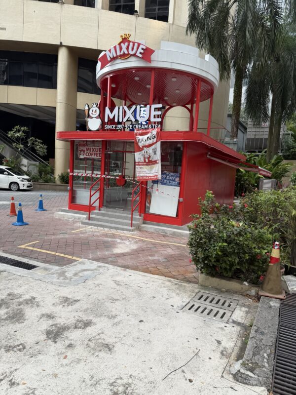 a small red building with a sign on the front