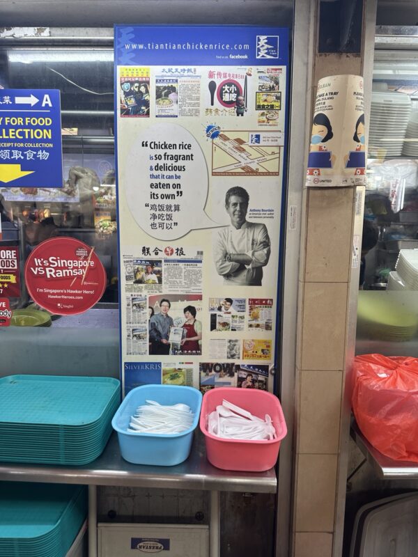 a poster on a wall with a sign and baskets of food
