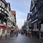 a street with buildings and people walking on it