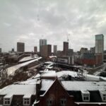 a city with snow on the roof