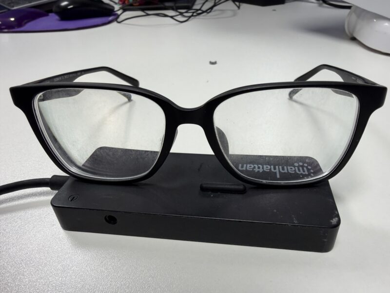 a pair of glasses on a black rectangular device