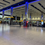 a large airport terminal with people walking around