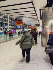 a group of people walking in an airport