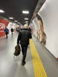 a man walking down a tunnel with a backpack