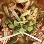 a bowl of soup with meat and vegetables