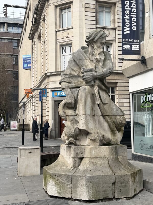 a statue of a woman in a city