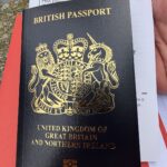 a hand holding a passport