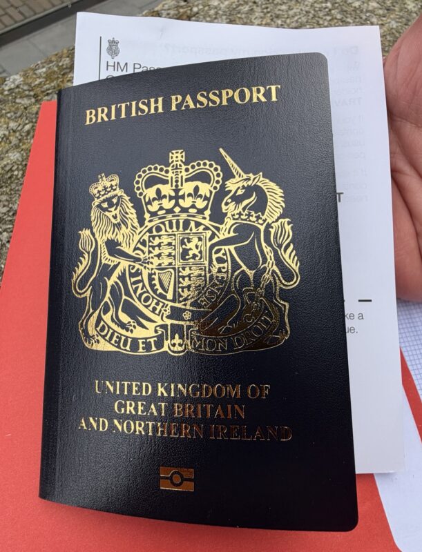 a hand holding a passport